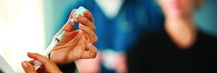 Medical professional prepares a syringe