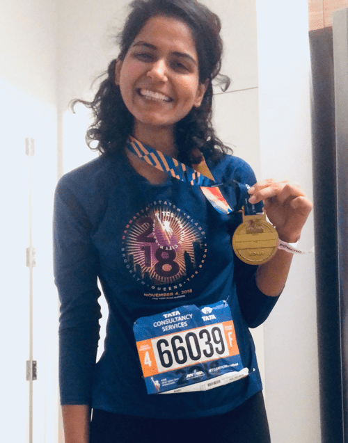 Kamal poses with 2018 NYC Marathon medal.