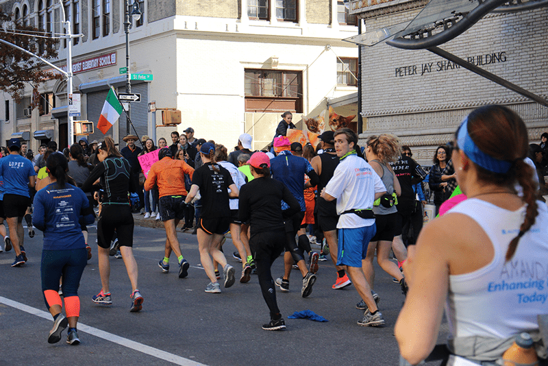 Associate Board member Jack Griffith turns as his supporters call his name at the 2018 NYC Marathon.