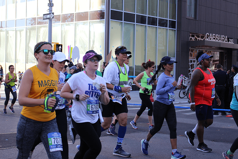 Rebecca Geary (middle) runs the 2018 NYC Marathon.