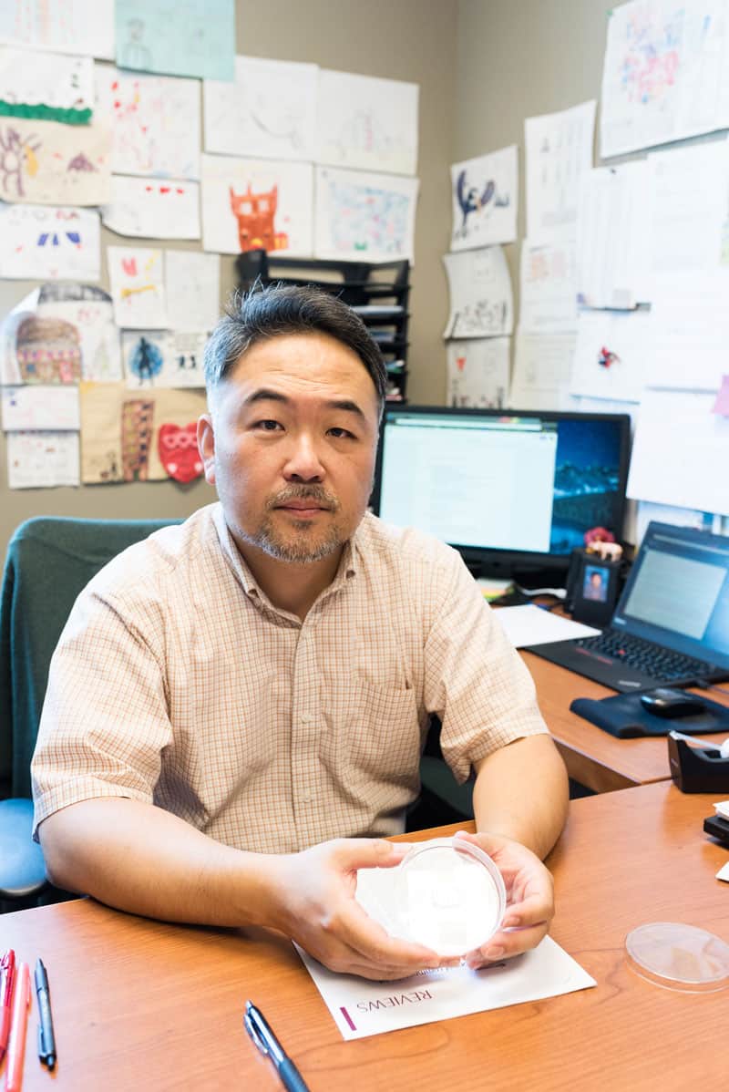 Dr. Hyun Jung Kim with CRC-on-a-chip device. Photo courtesy of Dr. Hyun Jung Kim