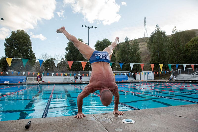 David J. Miller does a handstand after completing a million yards