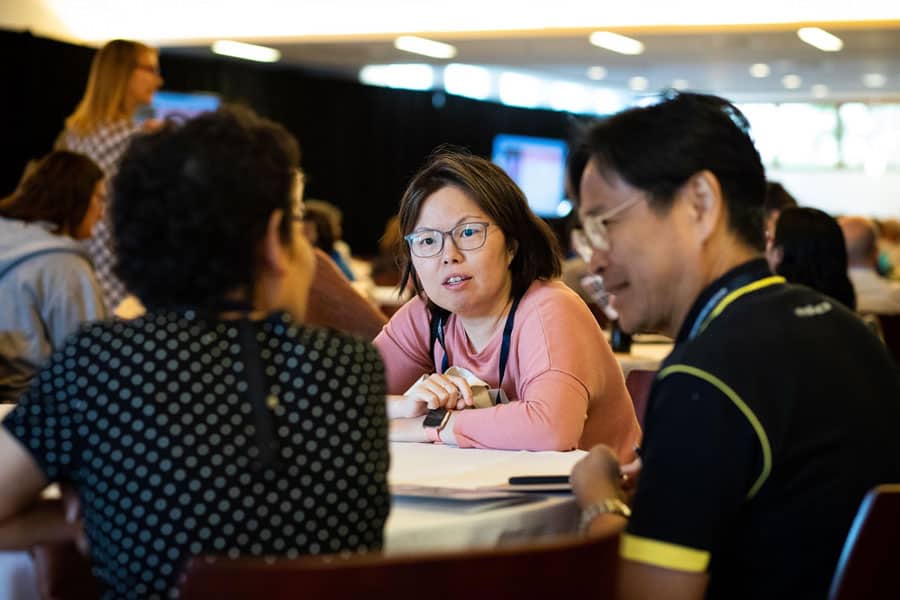 Summit attendees reviewing their notes and discussing the morning session. Photo by Adrianne Mathiowetz.