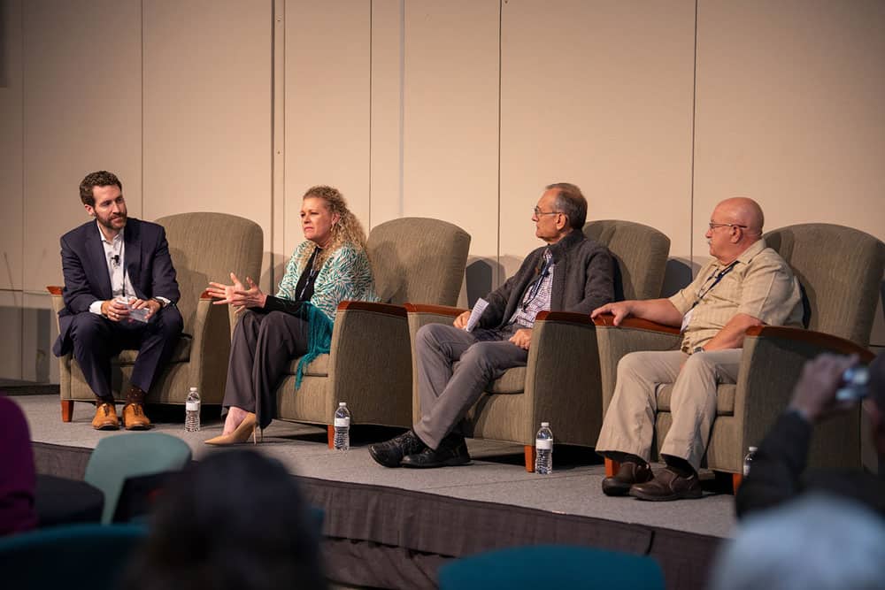 Moderator Brian Brewer (left) with panelists Isolde Artz, Samir Tanios, and Ron Speidel. Photo by Ranjani Groth