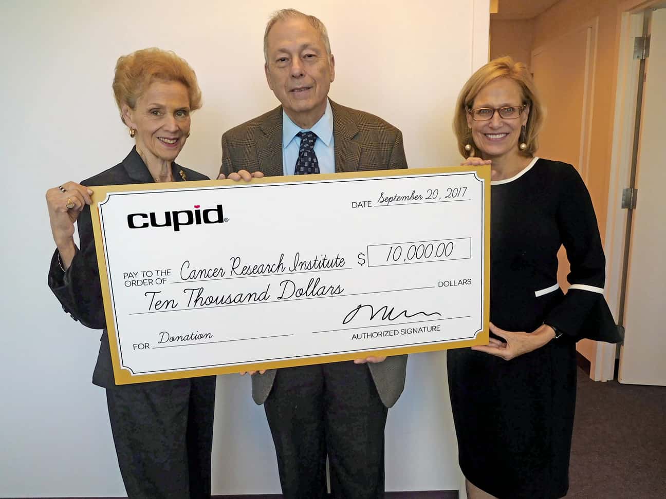 David and Marilyn Welsch (Cupid Intimates) presenting the check to Sharon Slade