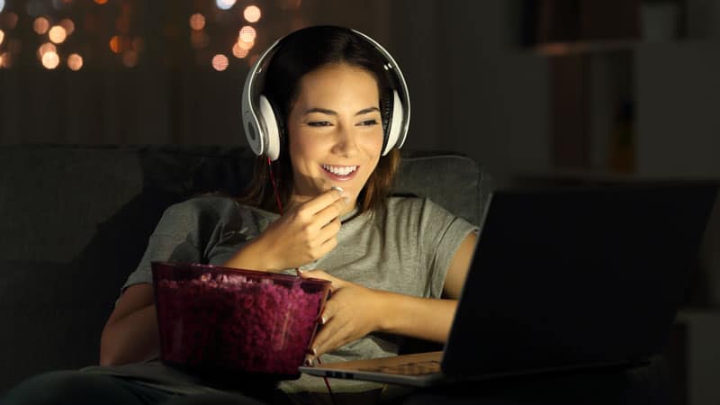 Young woman watching movie on laptop