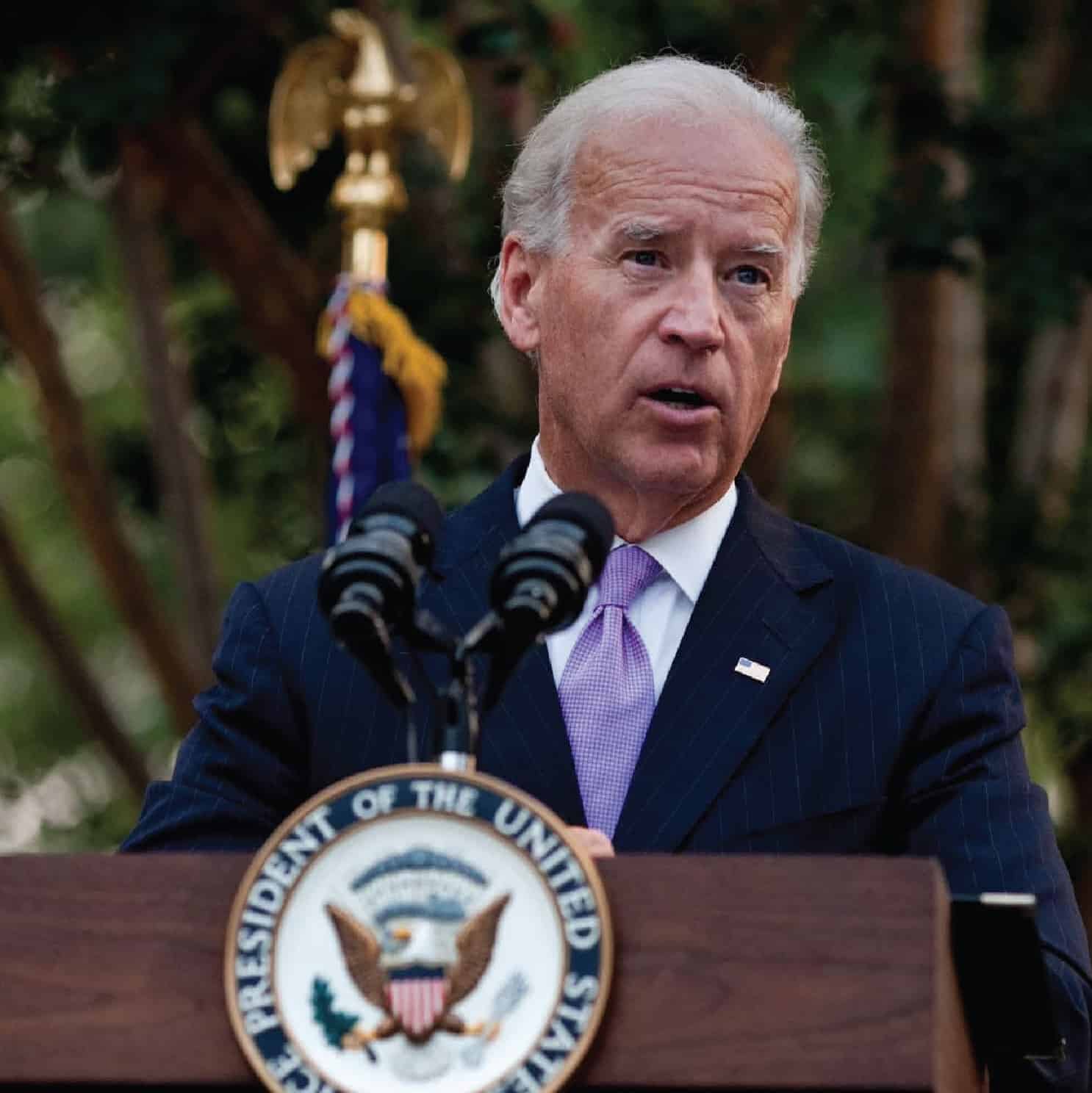 Joe Biden speaking behind a podium