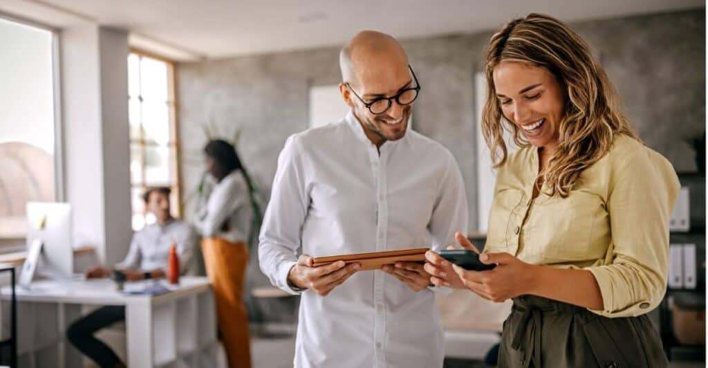 Two people looking at their mobile devices together