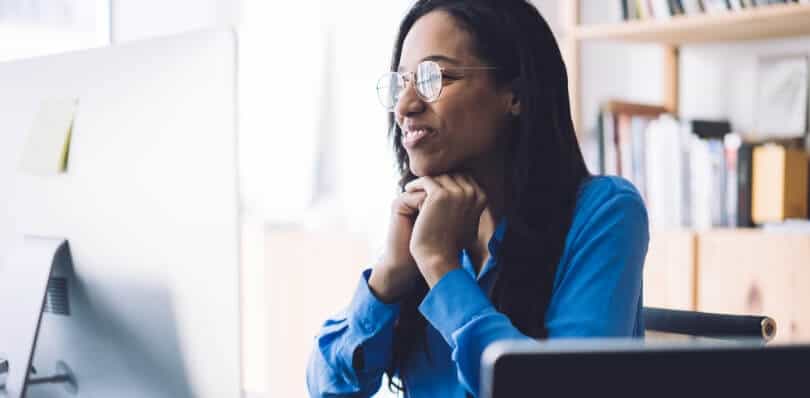 Woman looks at her external monitor