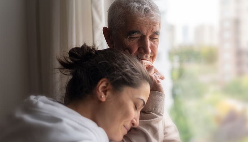 Daughter and father sharing a moment about how to support someone with cancer