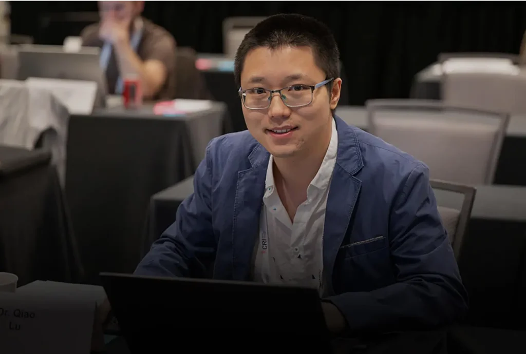 A postdoctoral fellow looks at the camera