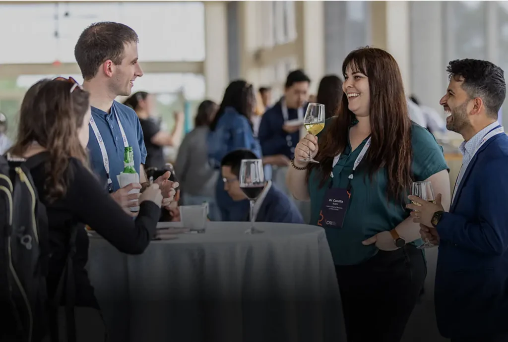 A group of people chat at a mixer
