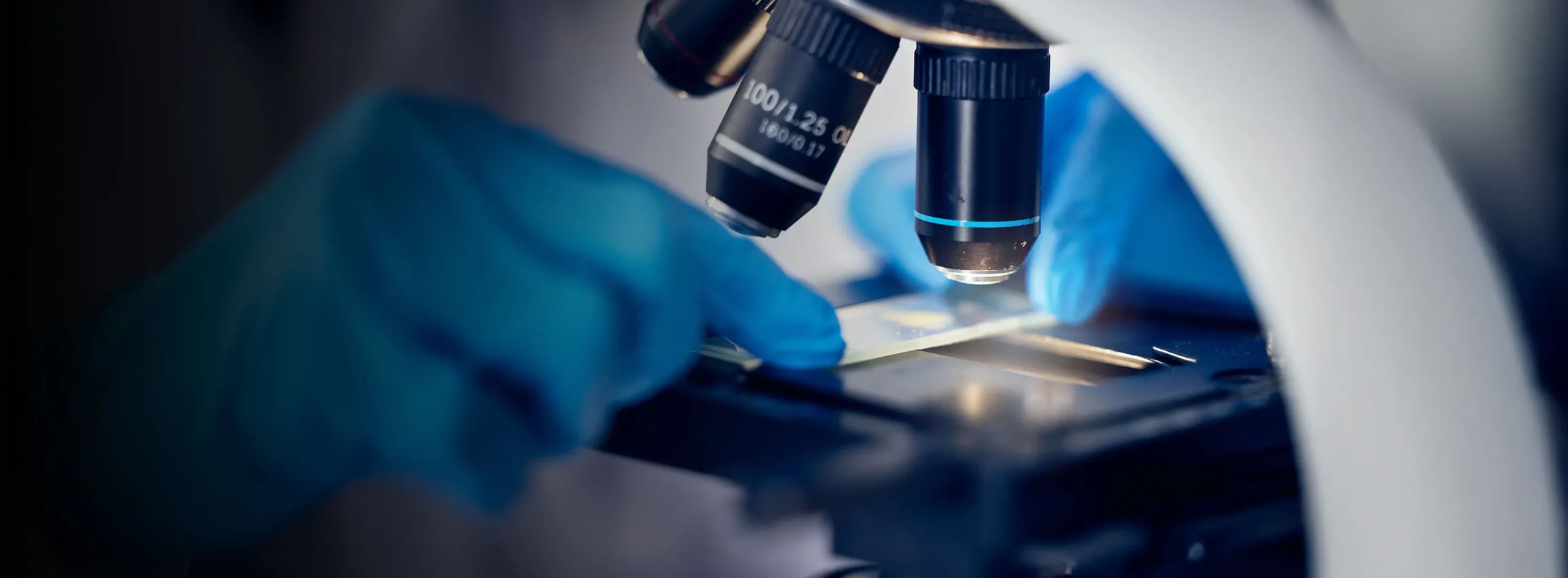 Close up of a scientist working with a microscope