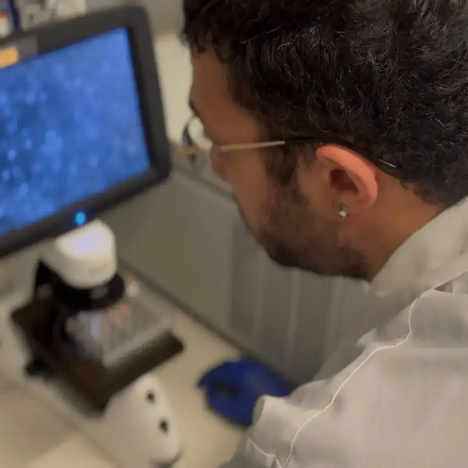 A scientist studying data on a screen.